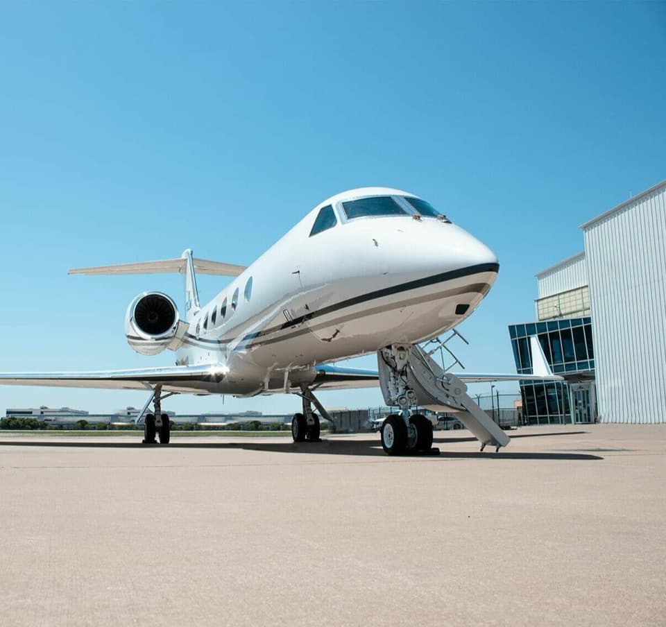 A private jet outside a hangar