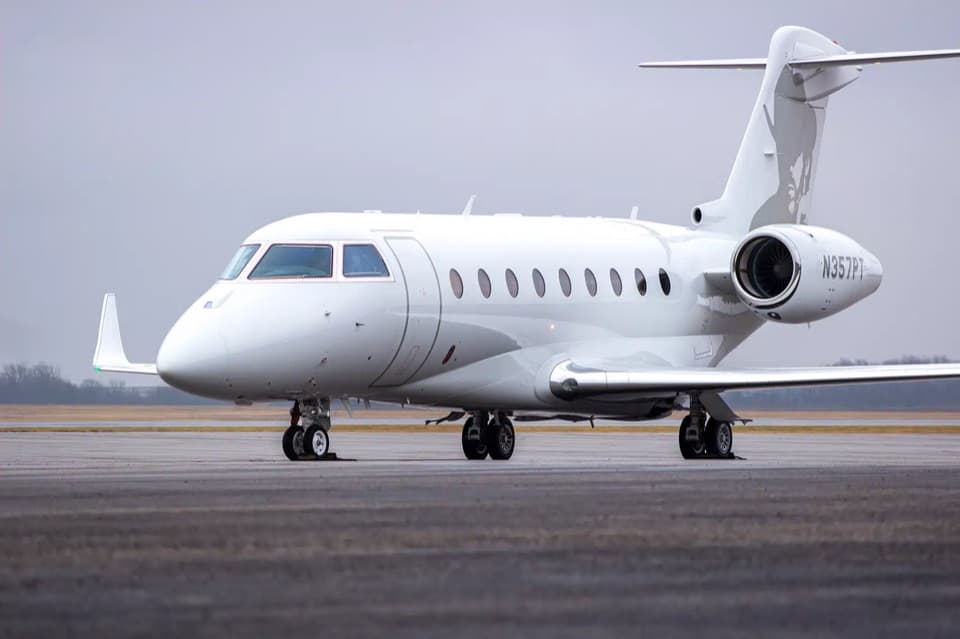 A private jet parked on the tarmac