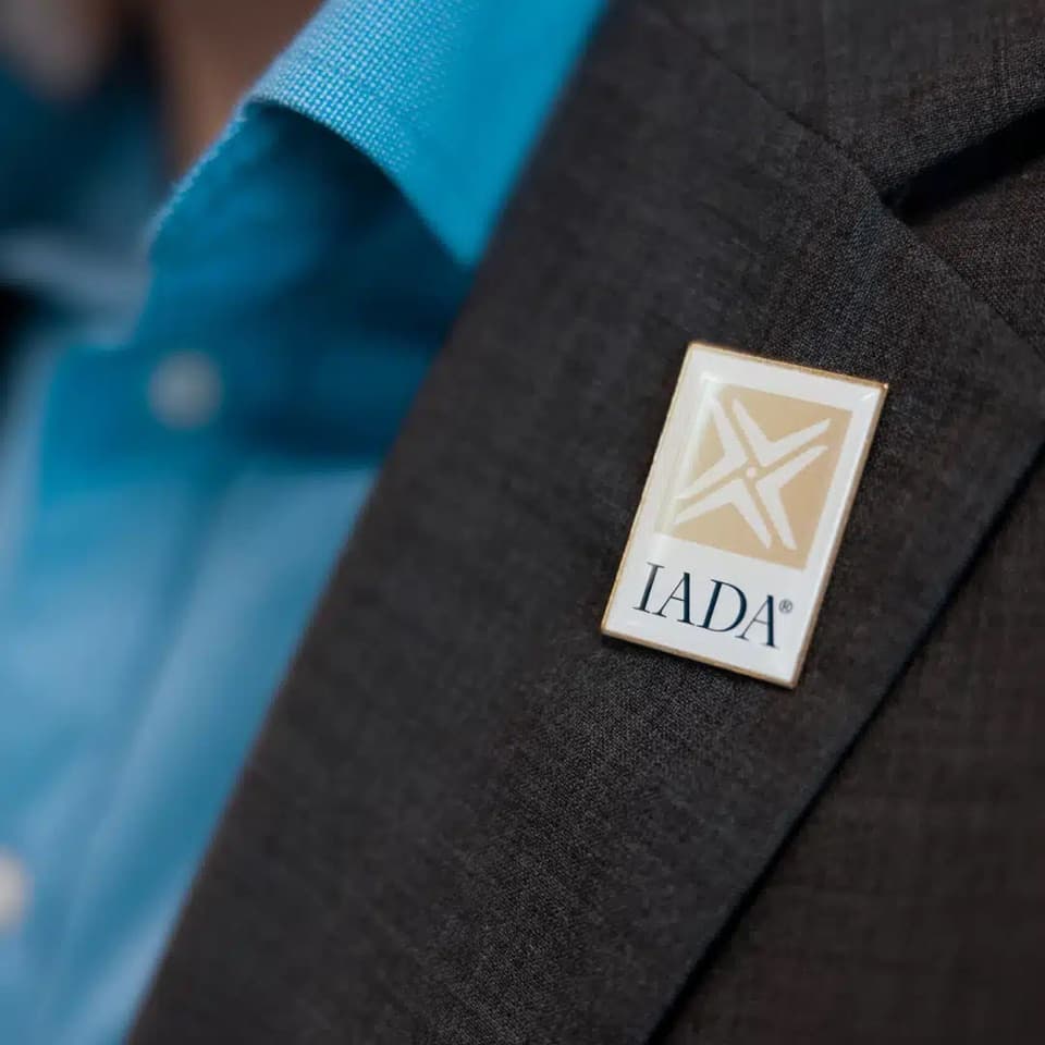IADA accredited dealer badge on a Leviate team member's lapel