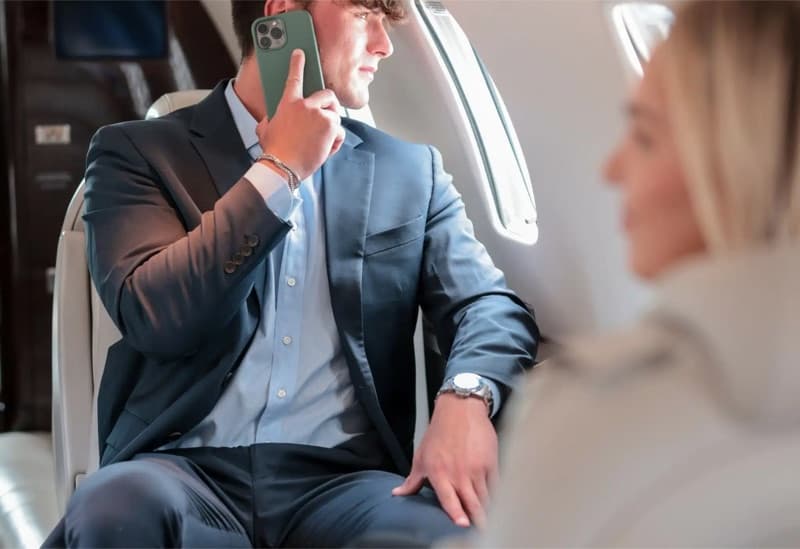 Executive traveler taking a call aboard a private jet