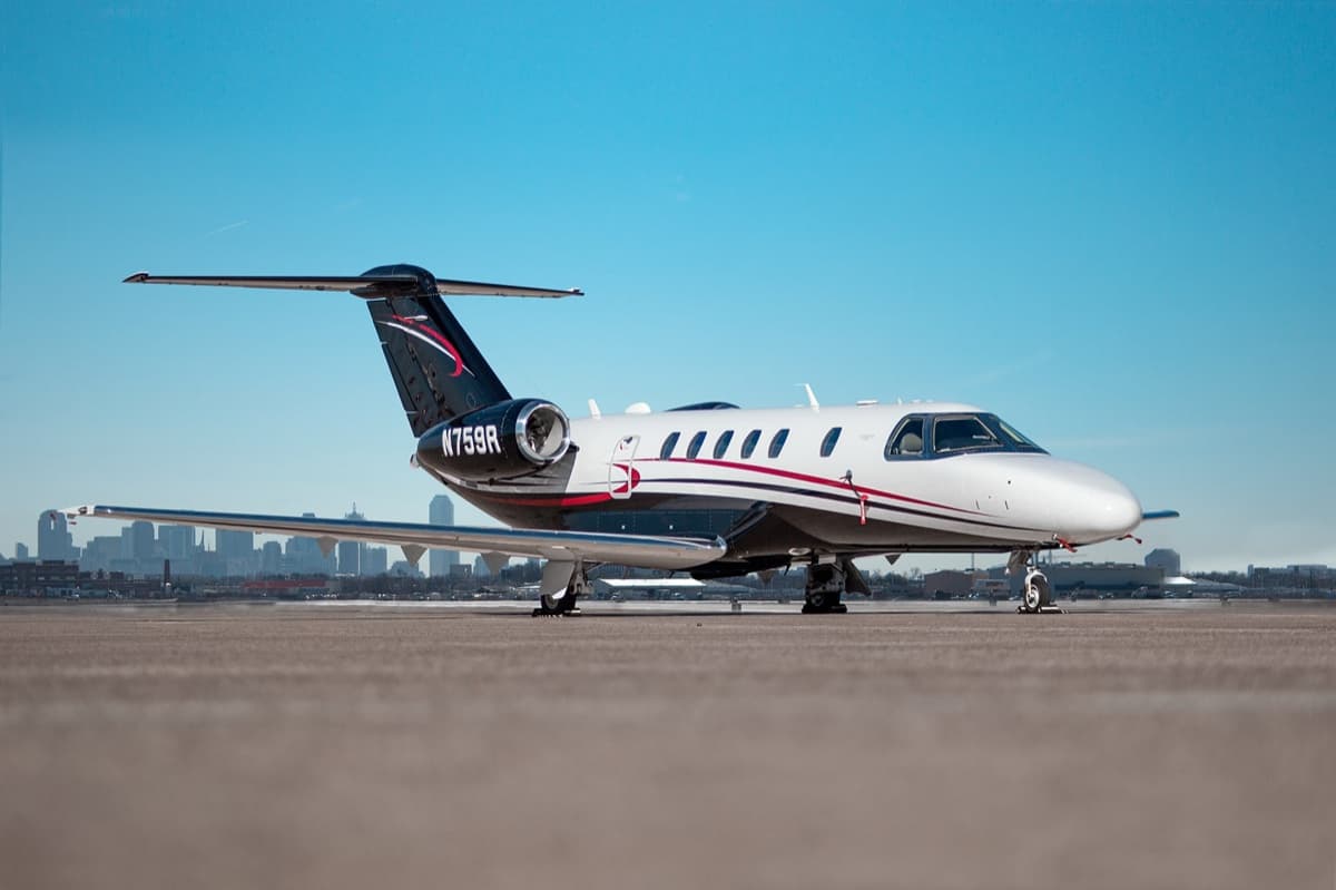 Cessna Citation CJ4 on the ramp with a city skyline behind